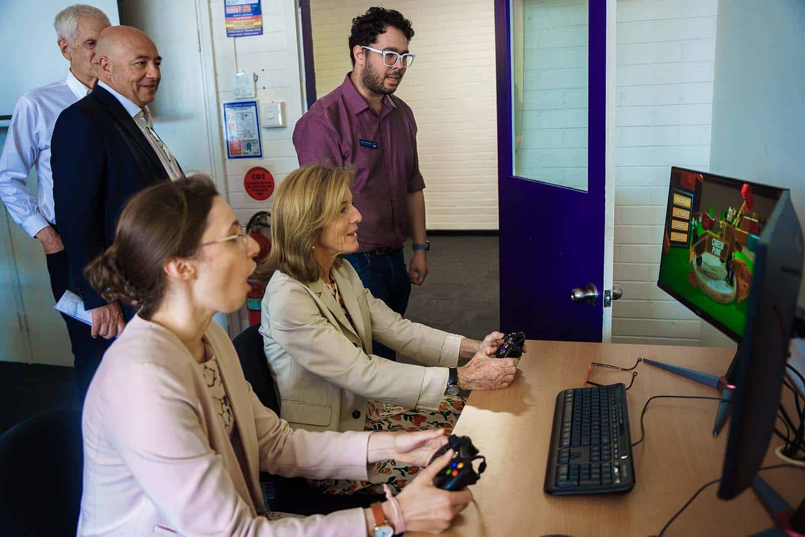 Ambassador Kennedy playing 'Cheesepunk', a game developed by AIE students.